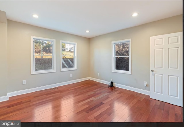 unfurnished room with hardwood / wood-style floors