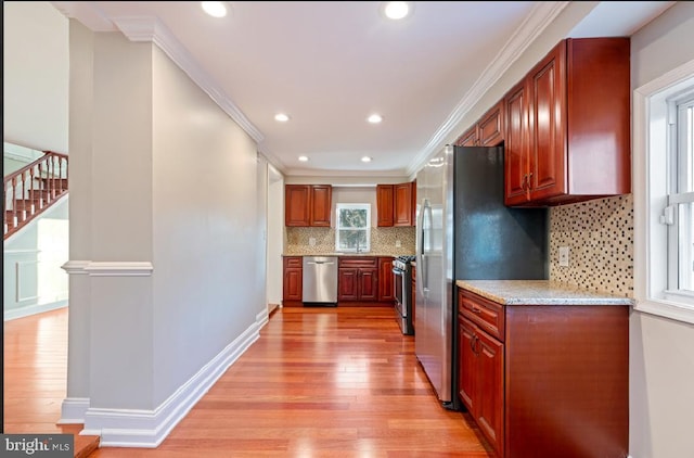 kitchen with decorative backsplash, ornamental molding, stainless steel appliances, and light wood-type flooring