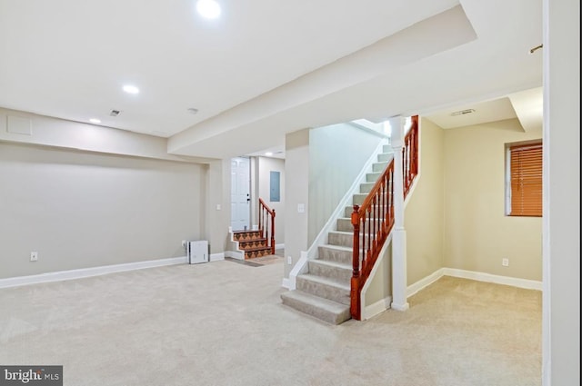 basement featuring light carpet