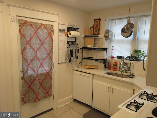 kitchen featuring white cabinets, white appliances, sink, and light tile patterned floors