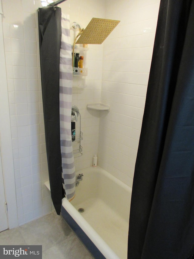 bathroom featuring tile patterned flooring and shower / bath combo