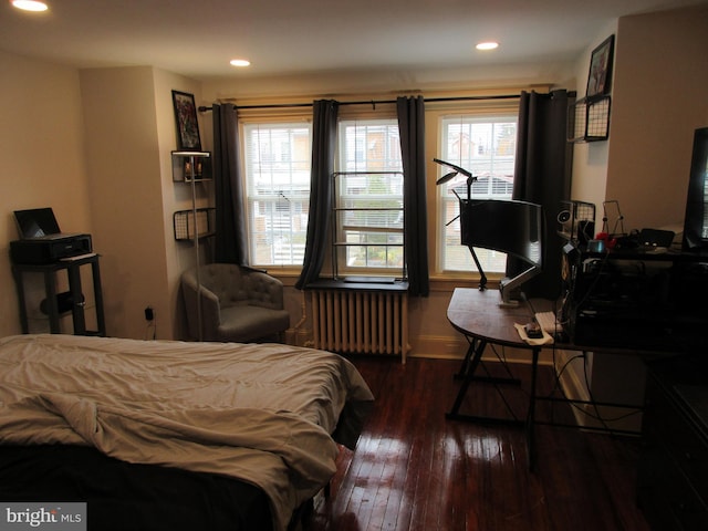 bedroom featuring dark hardwood / wood-style floors and radiator