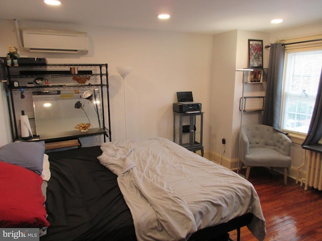 bedroom featuring an AC wall unit, radiator, and dark hardwood / wood-style flooring