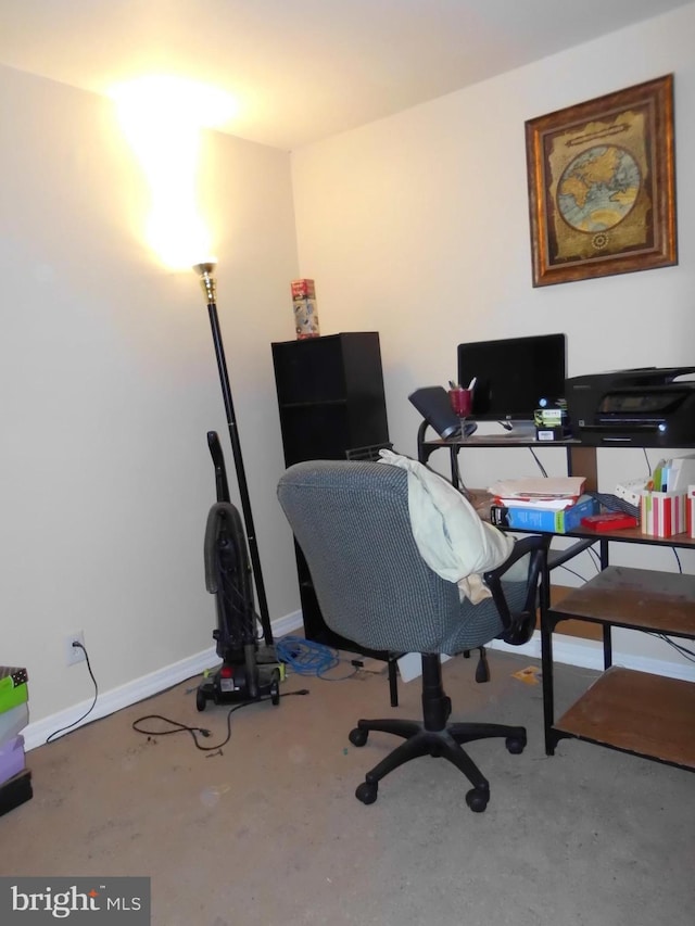 home office with concrete flooring