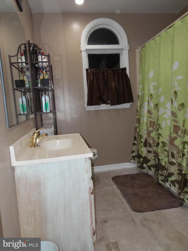 bathroom with vanity, tile patterned floors, and toilet