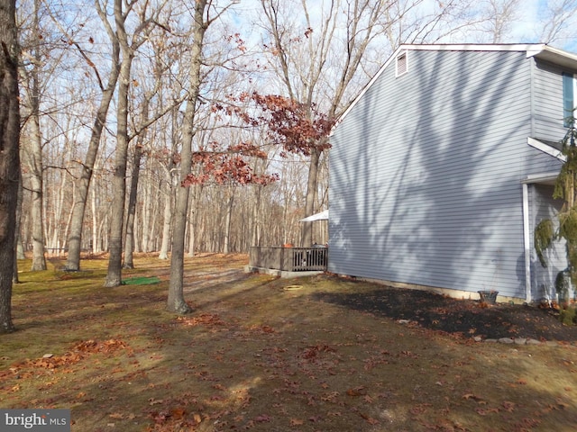 view of side of home featuring a wooden deck