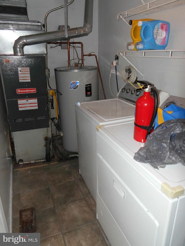 laundry area featuring tile patterned floors, separate washer and dryer, and electric water heater