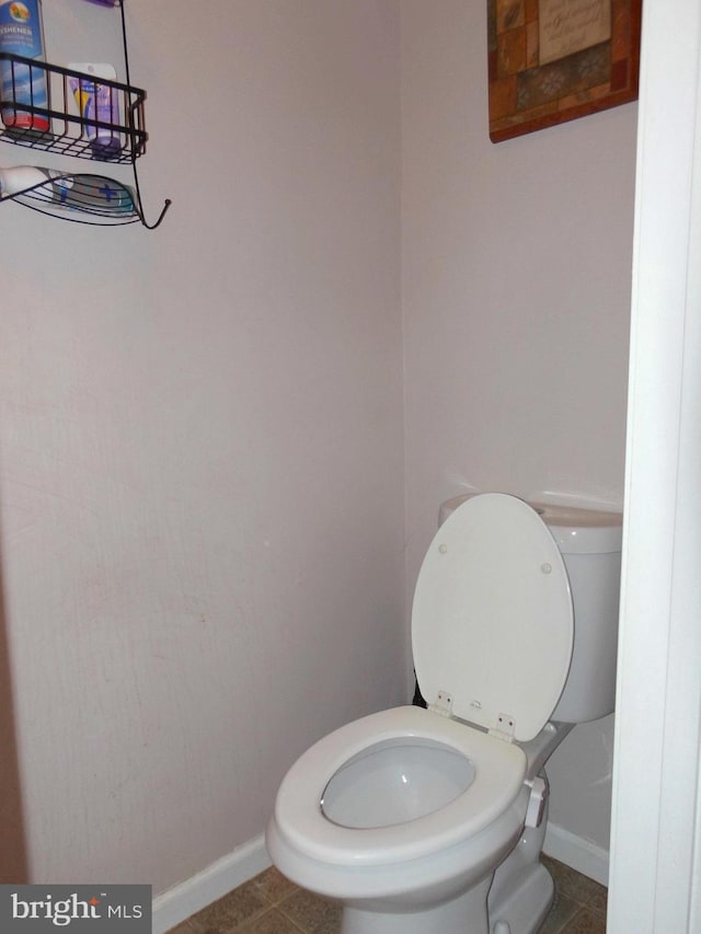 bathroom featuring toilet and tile patterned flooring