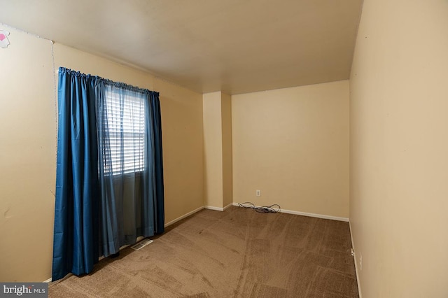 unfurnished room featuring carpet