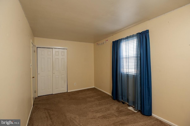 unfurnished bedroom featuring a closet and carpet