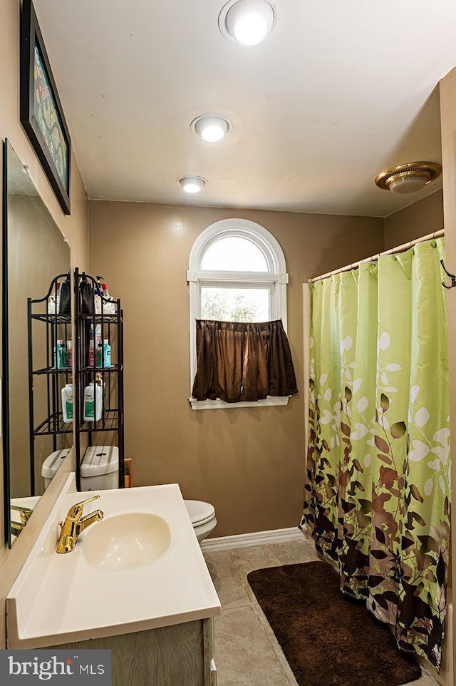 bathroom with vanity, tile patterned flooring, curtained shower, and toilet