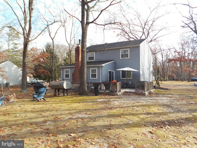 back of house featuring a wooden deck