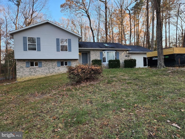 tri-level home featuring a garage and a front yard