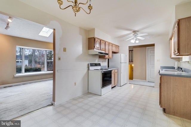 kitchen with a skylight, ceiling fan, sink, and white appliances