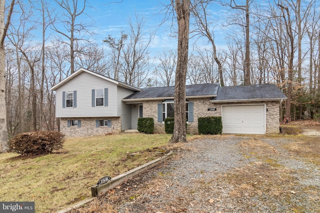 tri-level home featuring a front lawn and a garage