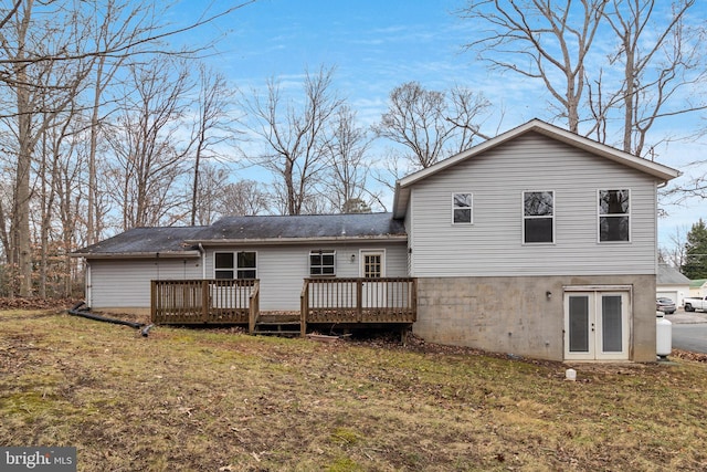 rear view of house featuring a deck, a yard, and french doors