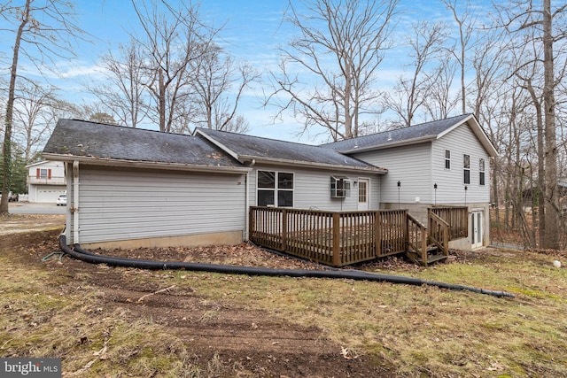 rear view of property featuring a deck