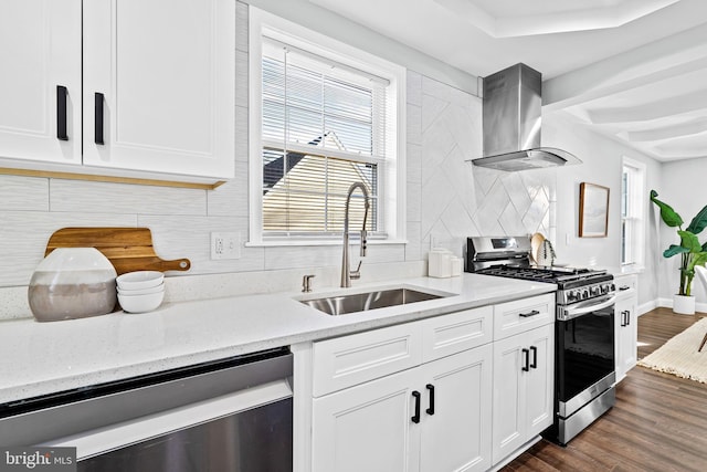 kitchen with backsplash, wall chimney range hood, appliances with stainless steel finishes, dark hardwood / wood-style flooring, and white cabinetry