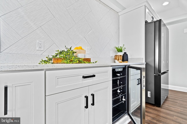 kitchen with white cabinets, dark hardwood / wood-style flooring, wine cooler, and stainless steel refrigerator