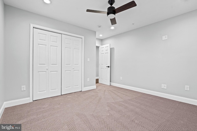 unfurnished bedroom featuring ceiling fan, a closet, and carpet floors