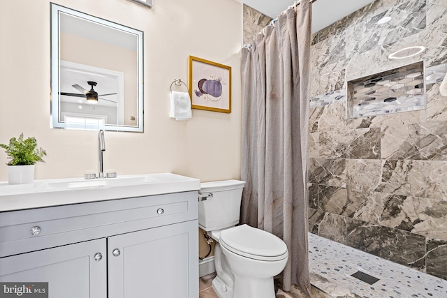 bathroom featuring ceiling fan, walk in shower, tile patterned floors, toilet, and vanity