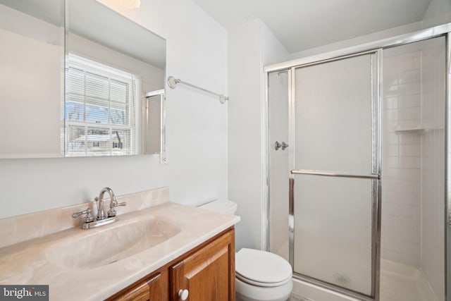 bathroom with vanity, toilet, and walk in shower