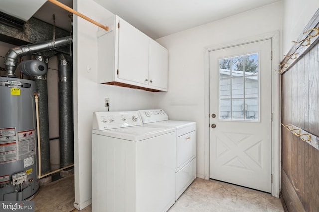 laundry room with cabinets, independent washer and dryer, and gas water heater