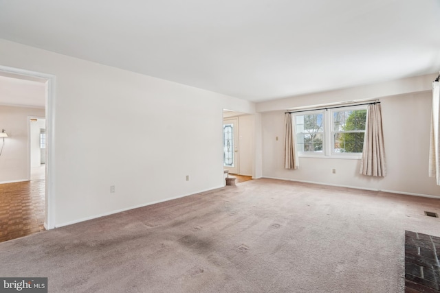 unfurnished room featuring a fireplace and light carpet