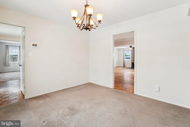 empty room with parquet floors and ceiling fan with notable chandelier