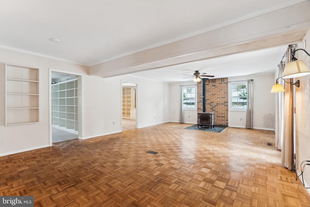 unfurnished living room featuring ceiling fan, a wood stove, ornamental molding, and parquet flooring