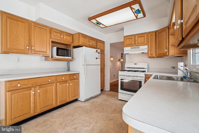 kitchen featuring white appliances and sink