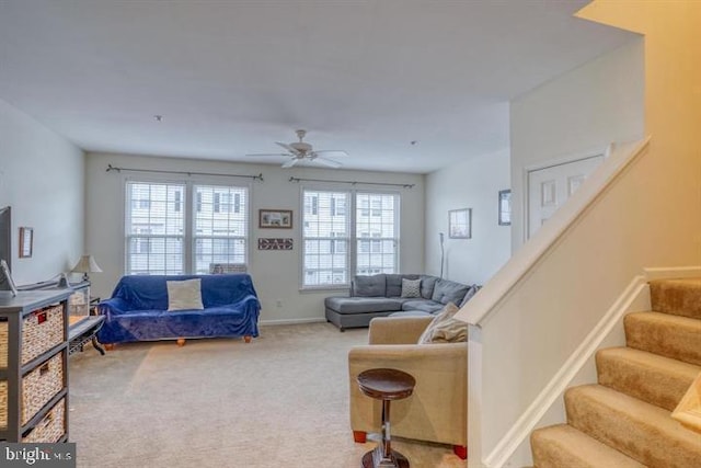 living room with light colored carpet, ceiling fan, and a healthy amount of sunlight