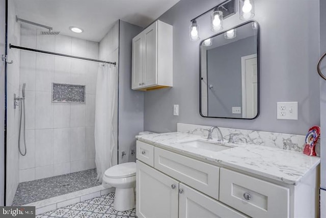 bathroom featuring vanity, curtained shower, and toilet