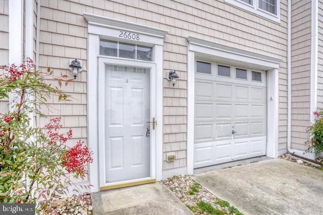 doorway to property with a garage