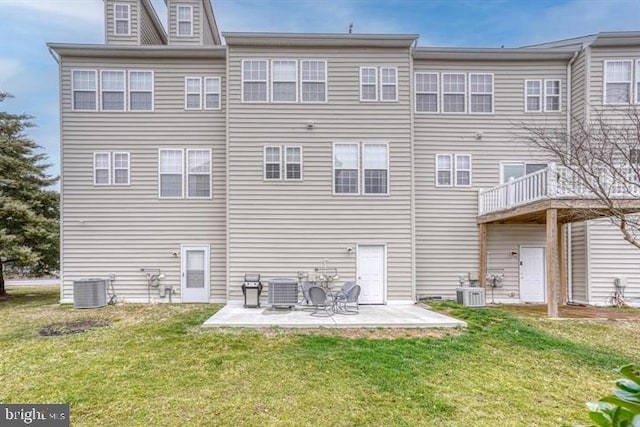 rear view of house with a yard, central AC, and a patio area