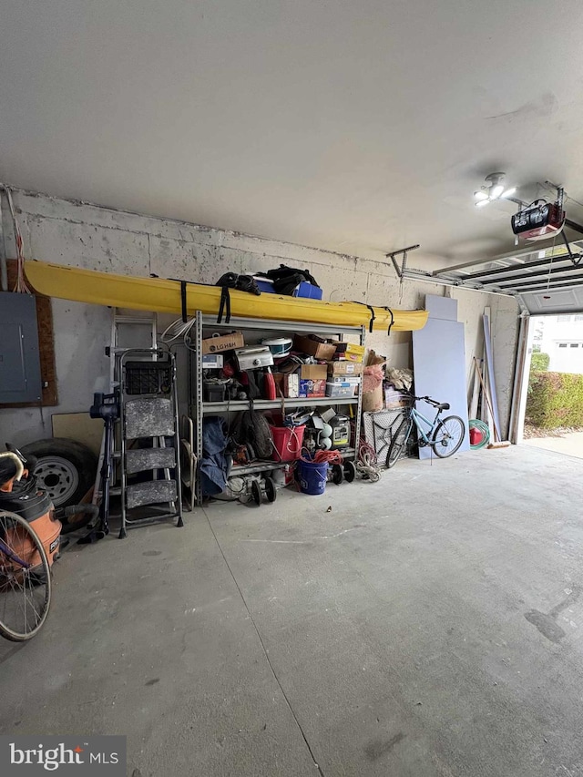 garage featuring electric panel and a garage door opener