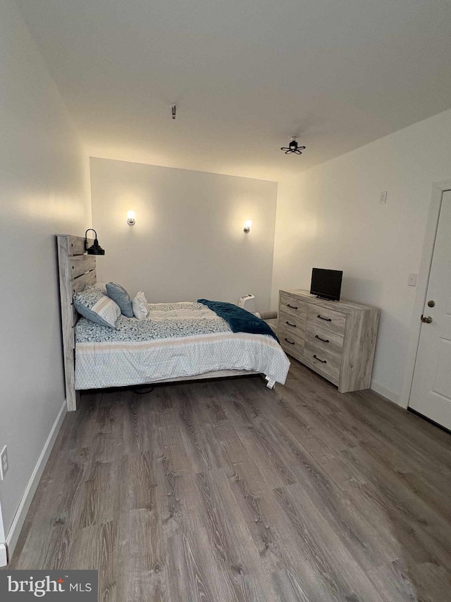 bedroom with hardwood / wood-style flooring