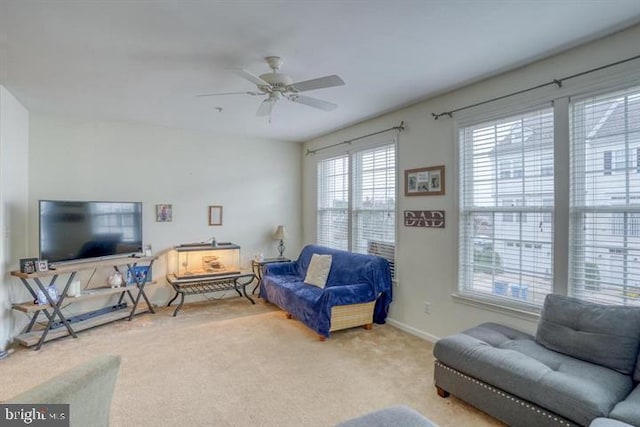 carpeted living room featuring ceiling fan