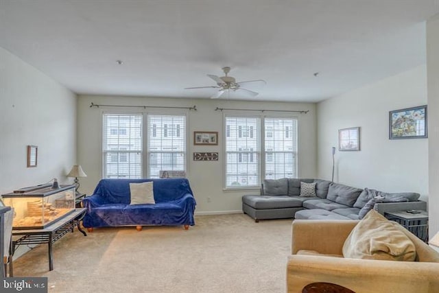 living room featuring a wealth of natural light, ceiling fan, and light colored carpet