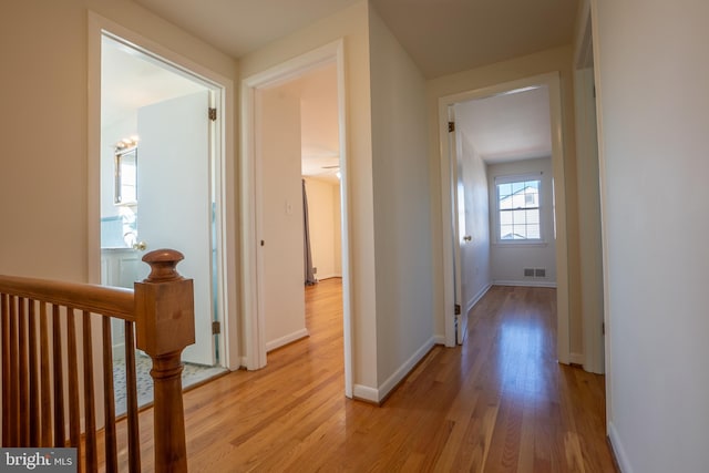 hall with light hardwood / wood-style floors