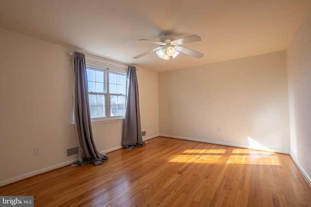 unfurnished room with ceiling fan and light hardwood / wood-style floors