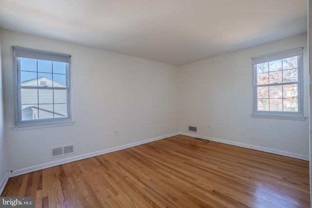 unfurnished room with wood-type flooring