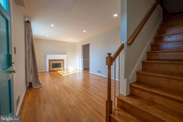 unfurnished living room featuring a fireplace and light wood-type flooring