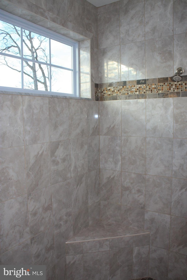 bathroom with a tile shower