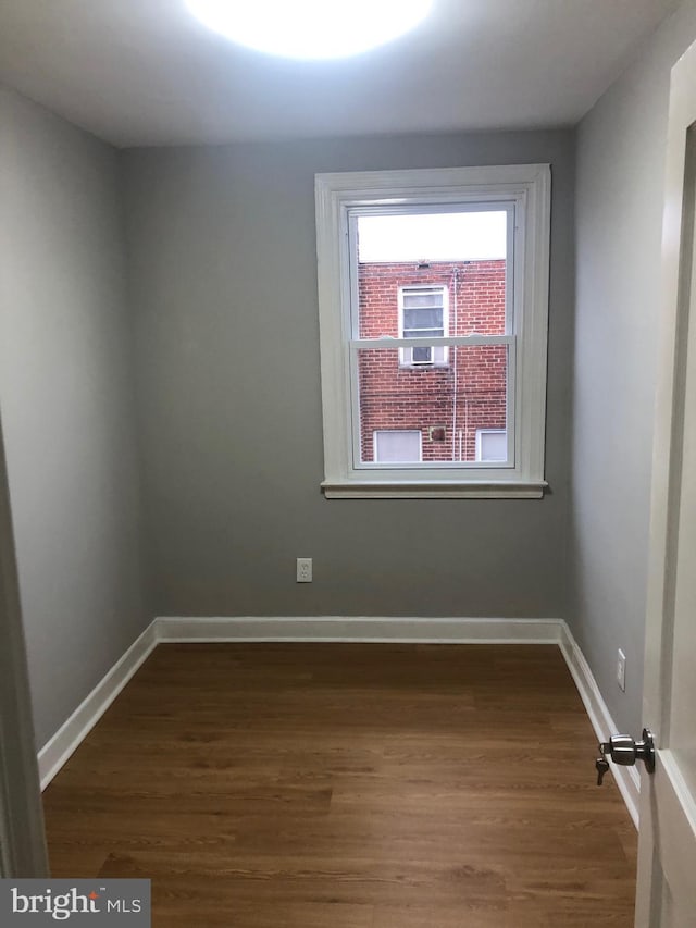 unfurnished room featuring dark hardwood / wood-style flooring