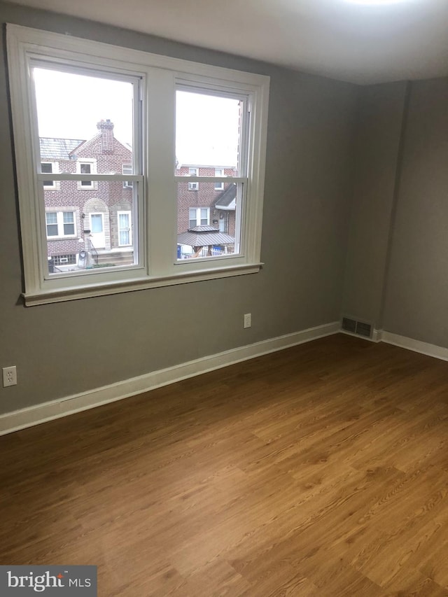 spare room with wood-type flooring