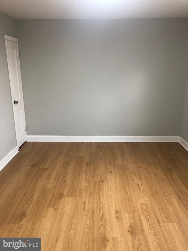 unfurnished room with light hardwood / wood-style flooring