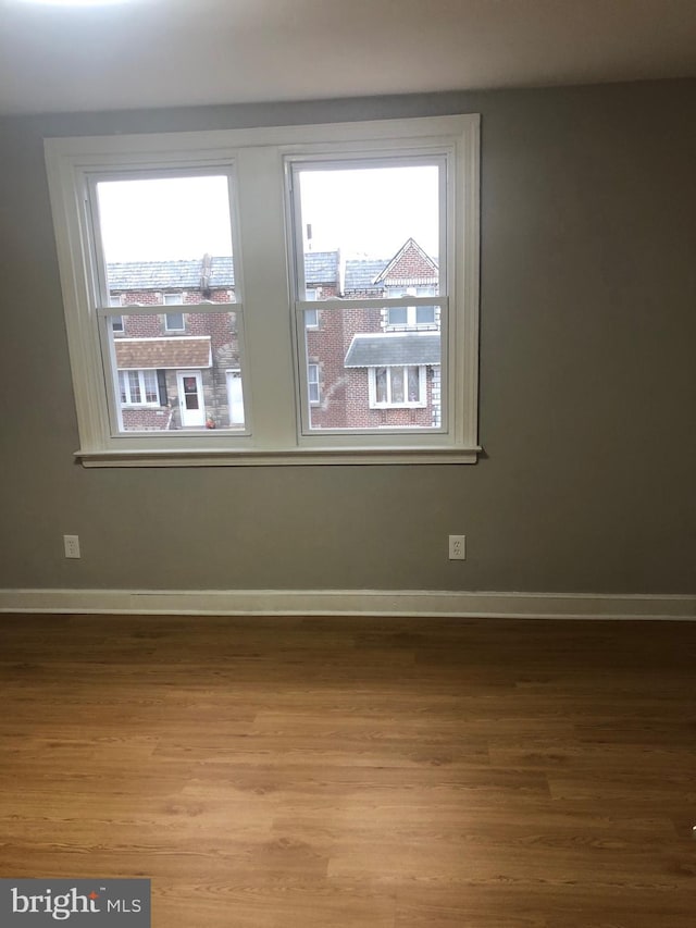 unfurnished room featuring hardwood / wood-style flooring