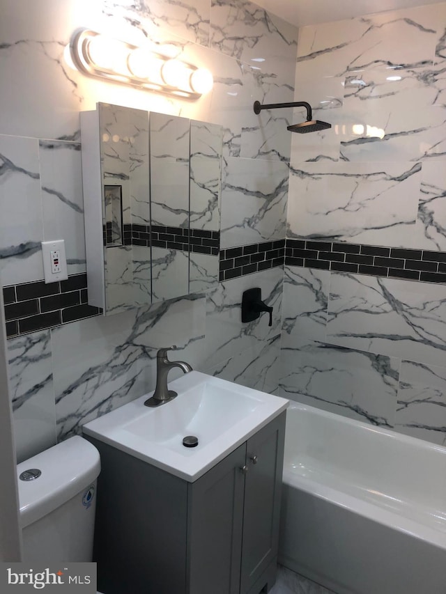 full bathroom featuring vanity, backsplash, tiled shower / bath, toilet, and tile walls