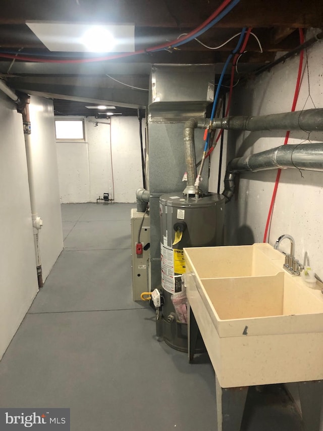 basement with gas water heater and sink